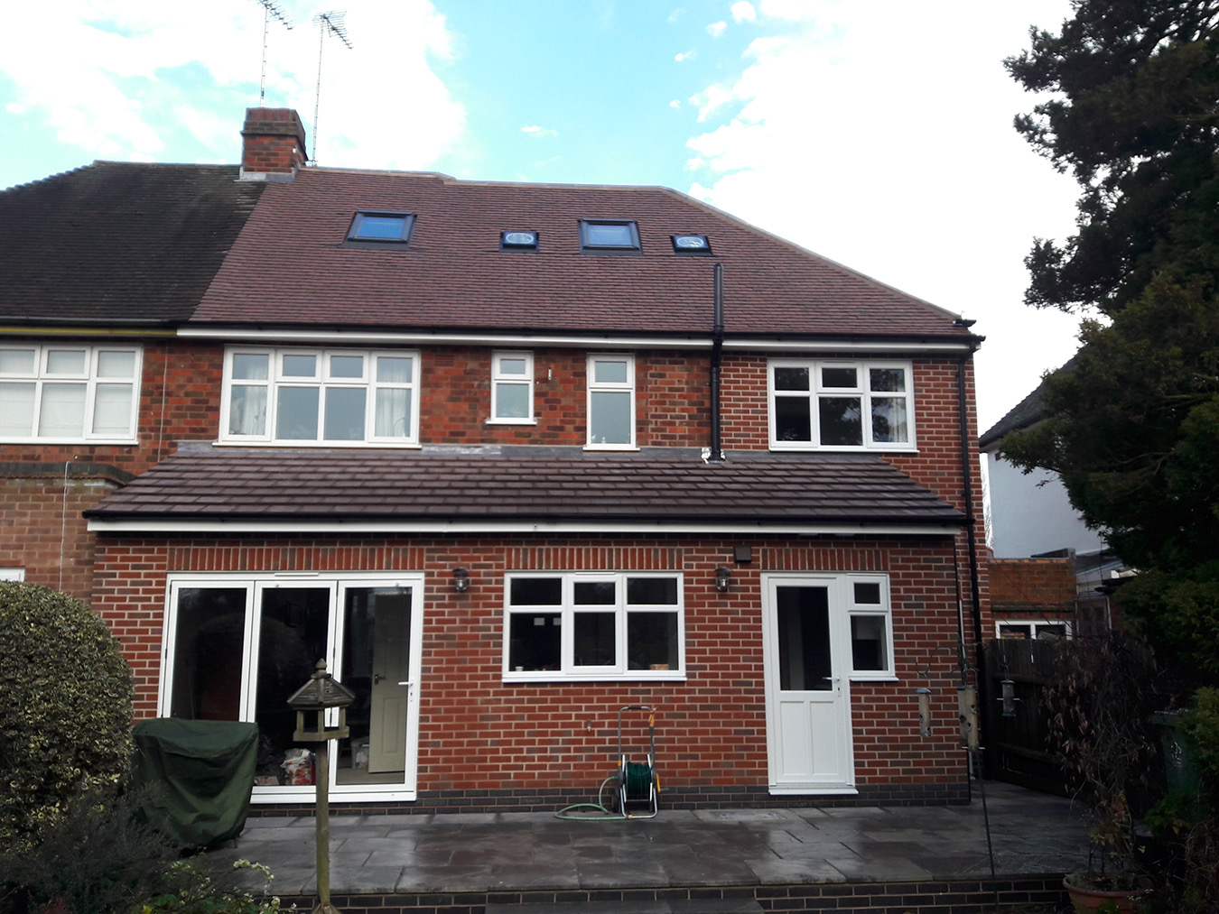 Completed brick home extension with patio doors